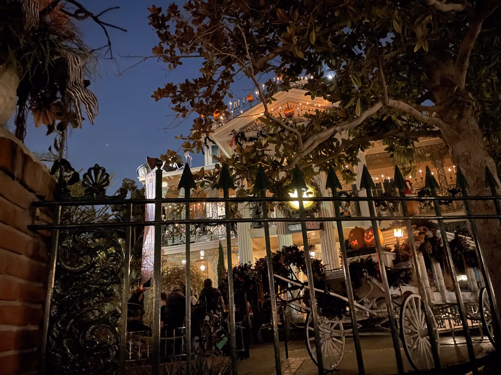 The Haunted Mansion attraction at Disneyland in Anaheim decorated for the holidays with pumpkins at night.