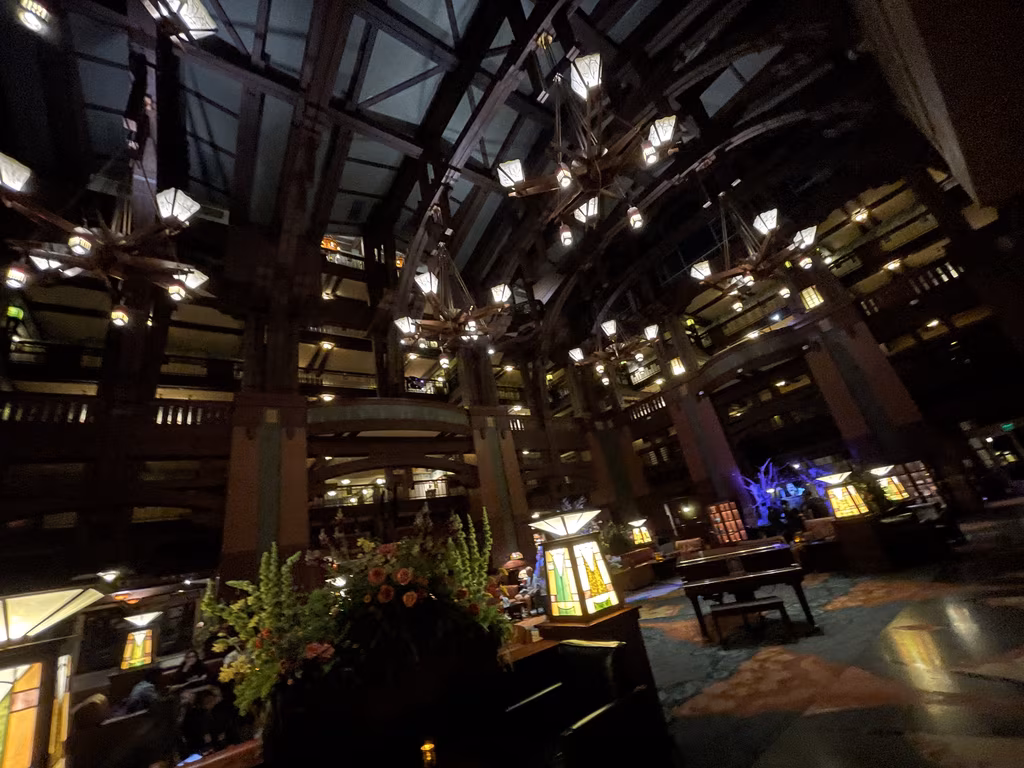 The lobby of Disney’s Grand Californian Hotel features stunning woodwork and towering, lodge-inspired lantern chandeliers.