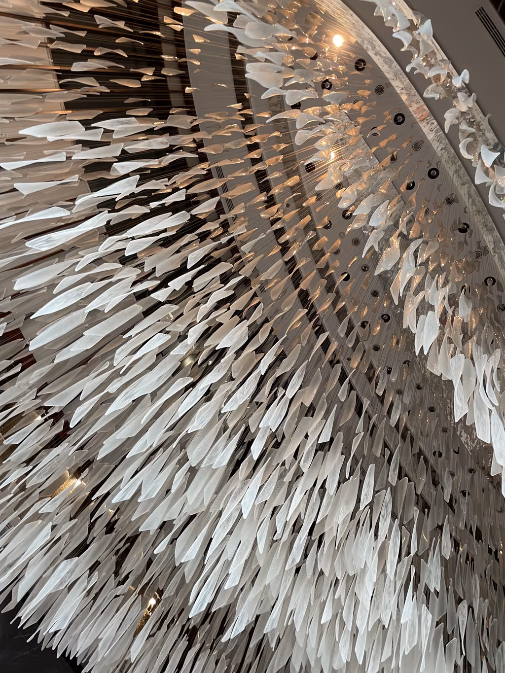 A stunning, modern glass chandelier made of many dangling translucent glass shards at the Andaz Capital Gate hotel in Abu Dhabi.