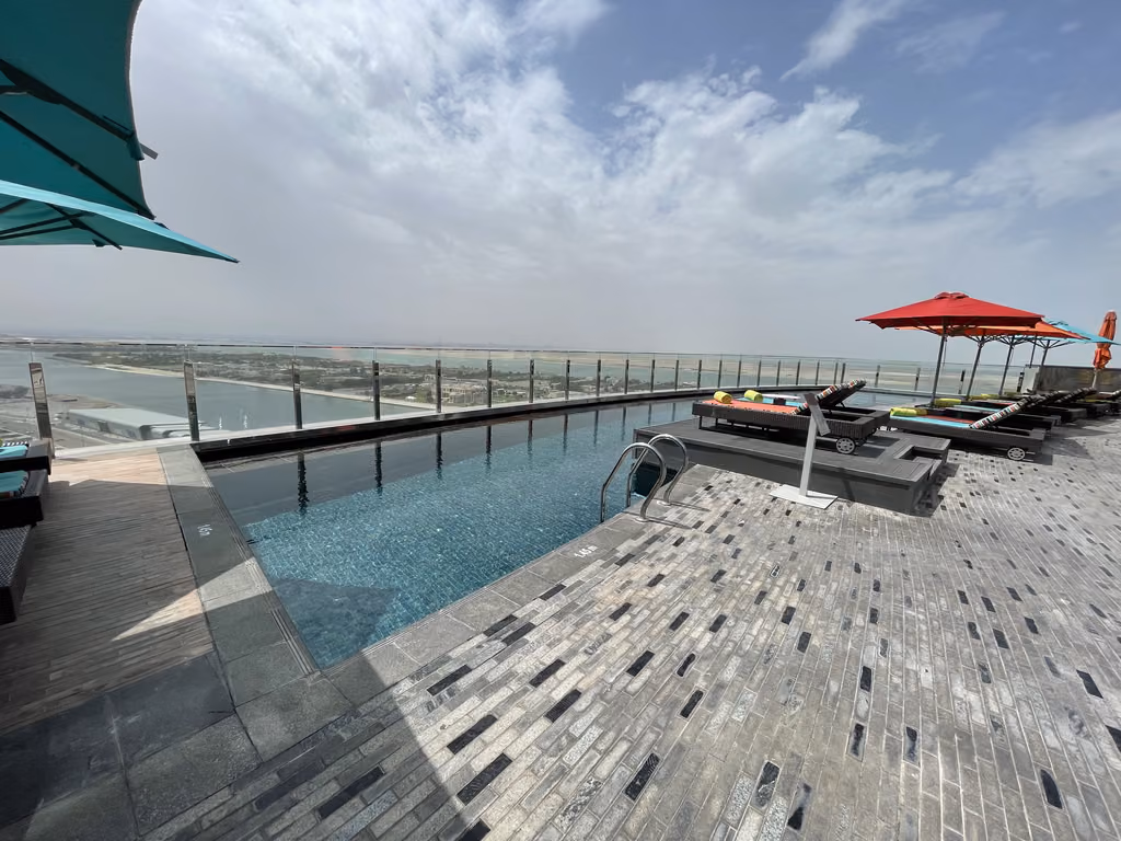 The rooftop infinity pool at Andaz Capital Gate offers stunning, panoramic views of Abu Dhabi.