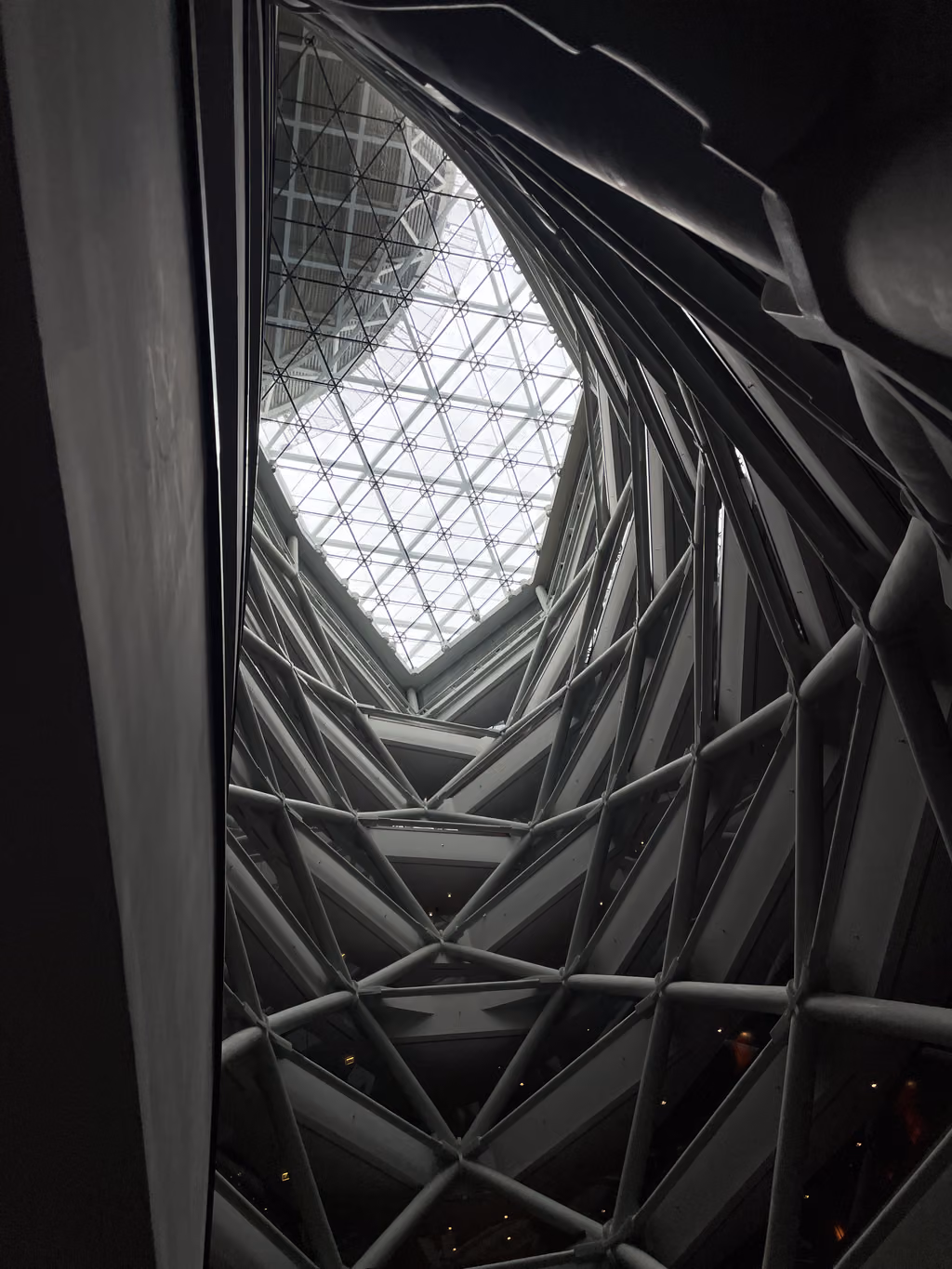 The dramatic, leaning atrium at Andaz Capital Gate showcases the hotel's breathtaking architectural design from below.