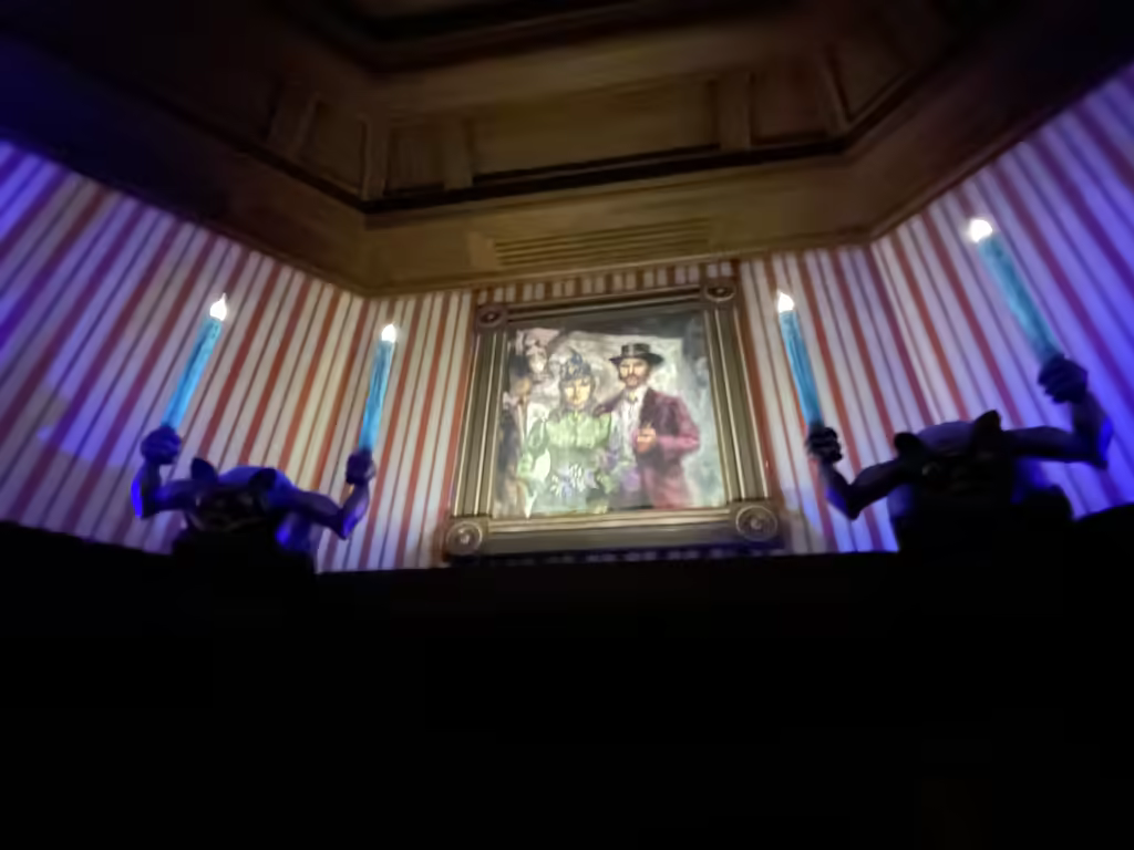 The iconic, eerie portraits in the Phantom Manor queue set the perfect haunted attraction mood.