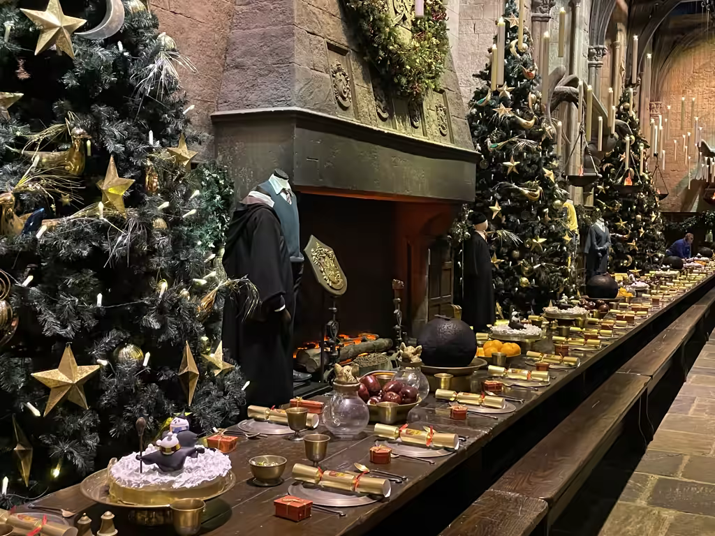 The Great Hall at the Harry Potter Studio Tour looks magical with festive Christmas tree decorations.
