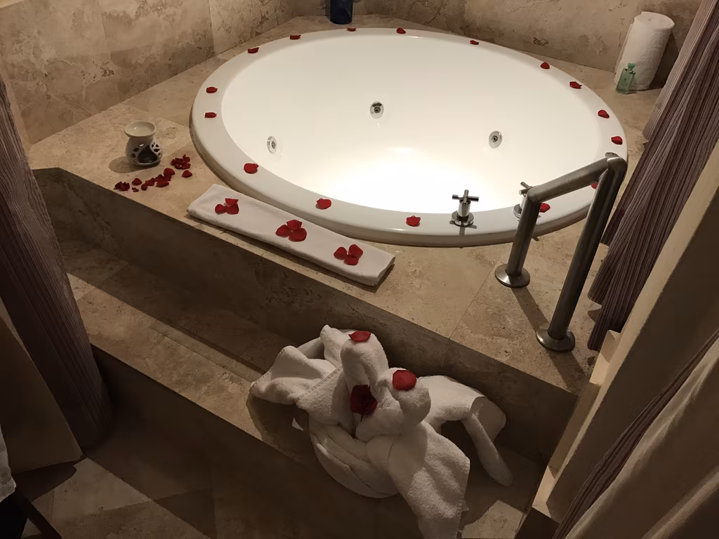 The romantic in-suite whirlpool tub is beautifully decorated with rose petals for a perfect retreat.