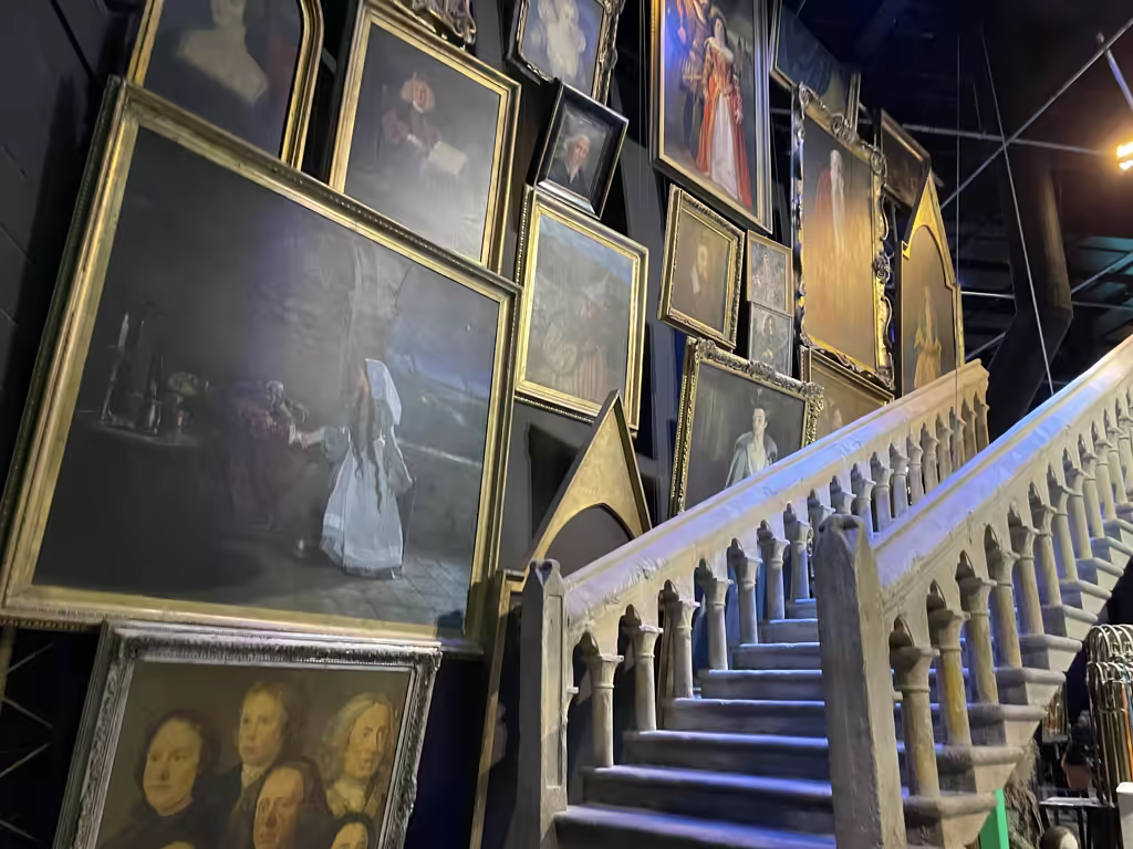 Experience the magic of Hogwarts as moving portraits line the grand staircase at the studio tour.