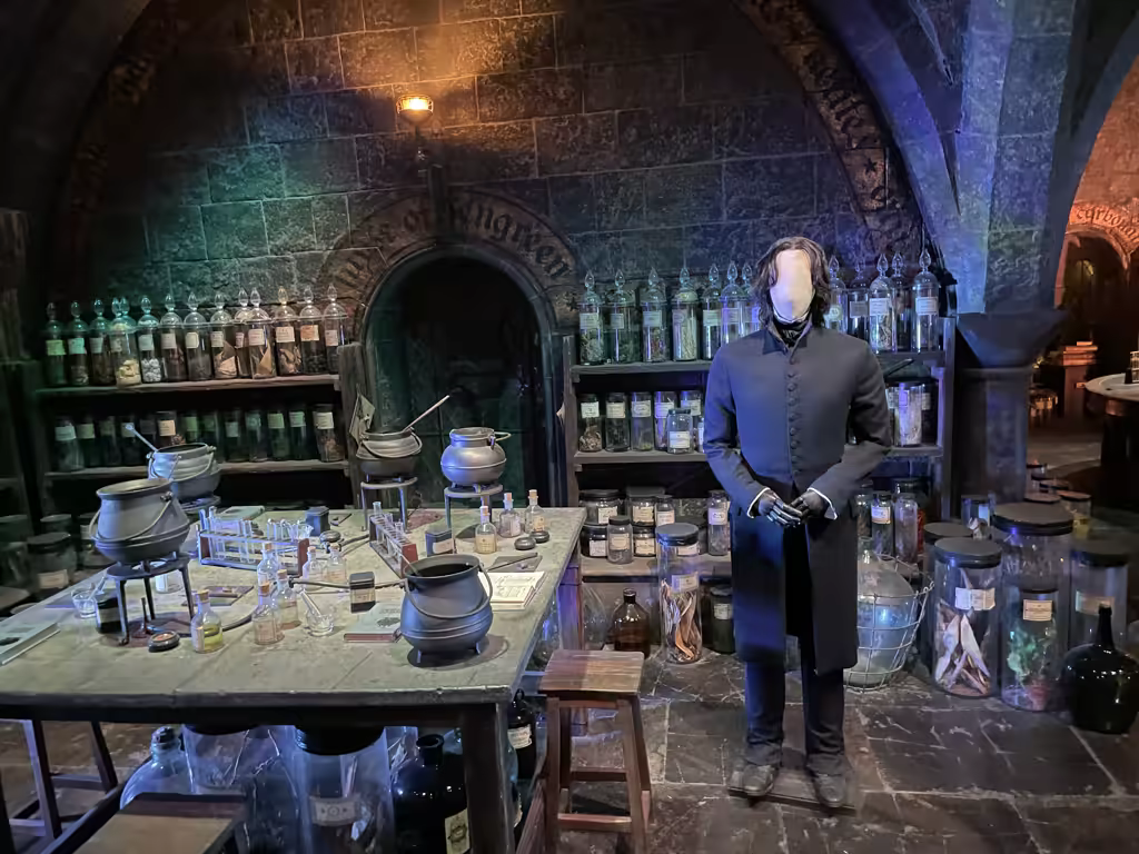 Step into Professor Snape’s dimly lit potions classroom and explore the authentic set design details.