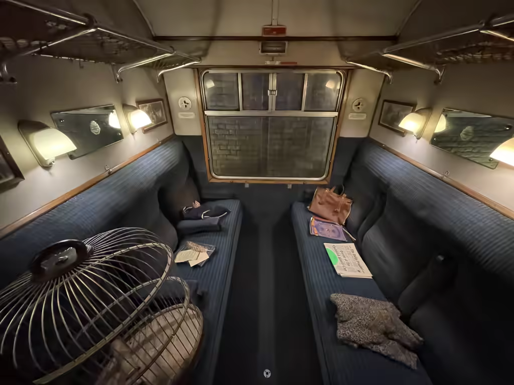 Interior of a vintage Hogwarts Express train carriage at the Harry Potter Studio Tour London.