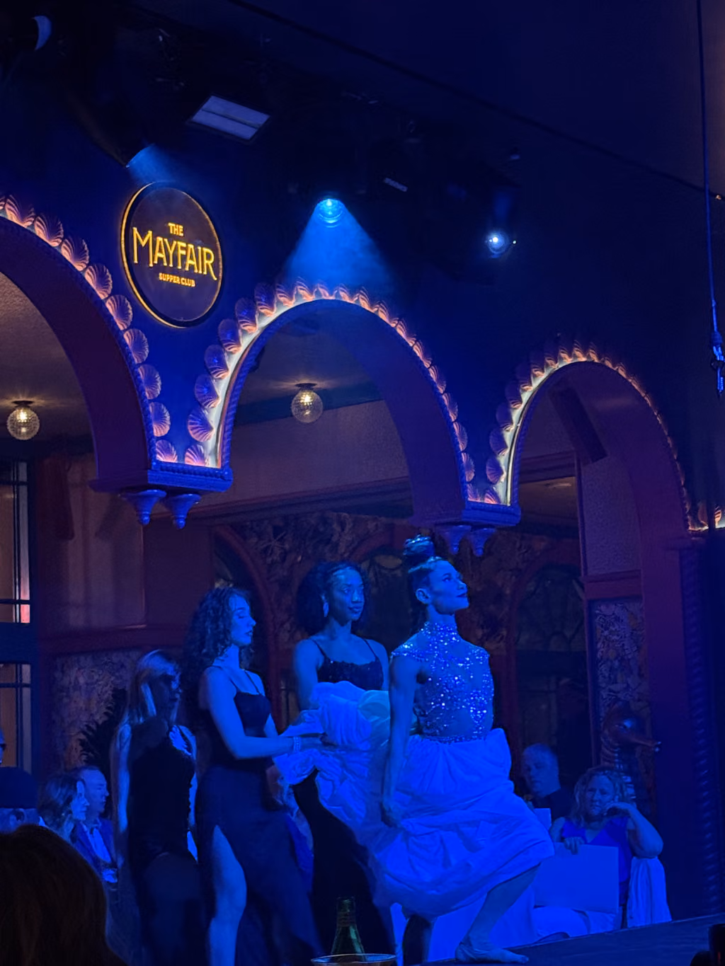 Performers in elegant attire on stage at The Mayfair Supper Club in Las Vegas.