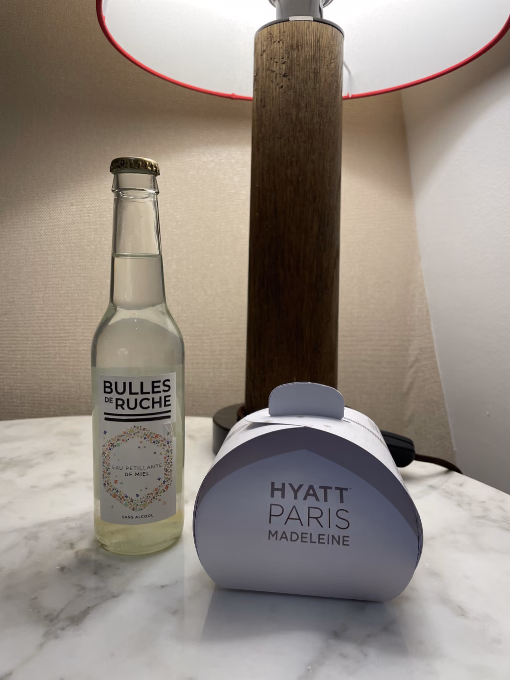 A sweet welcome gift of sparkling honey water and treats from our room at Hyatt Paris Madeleine.