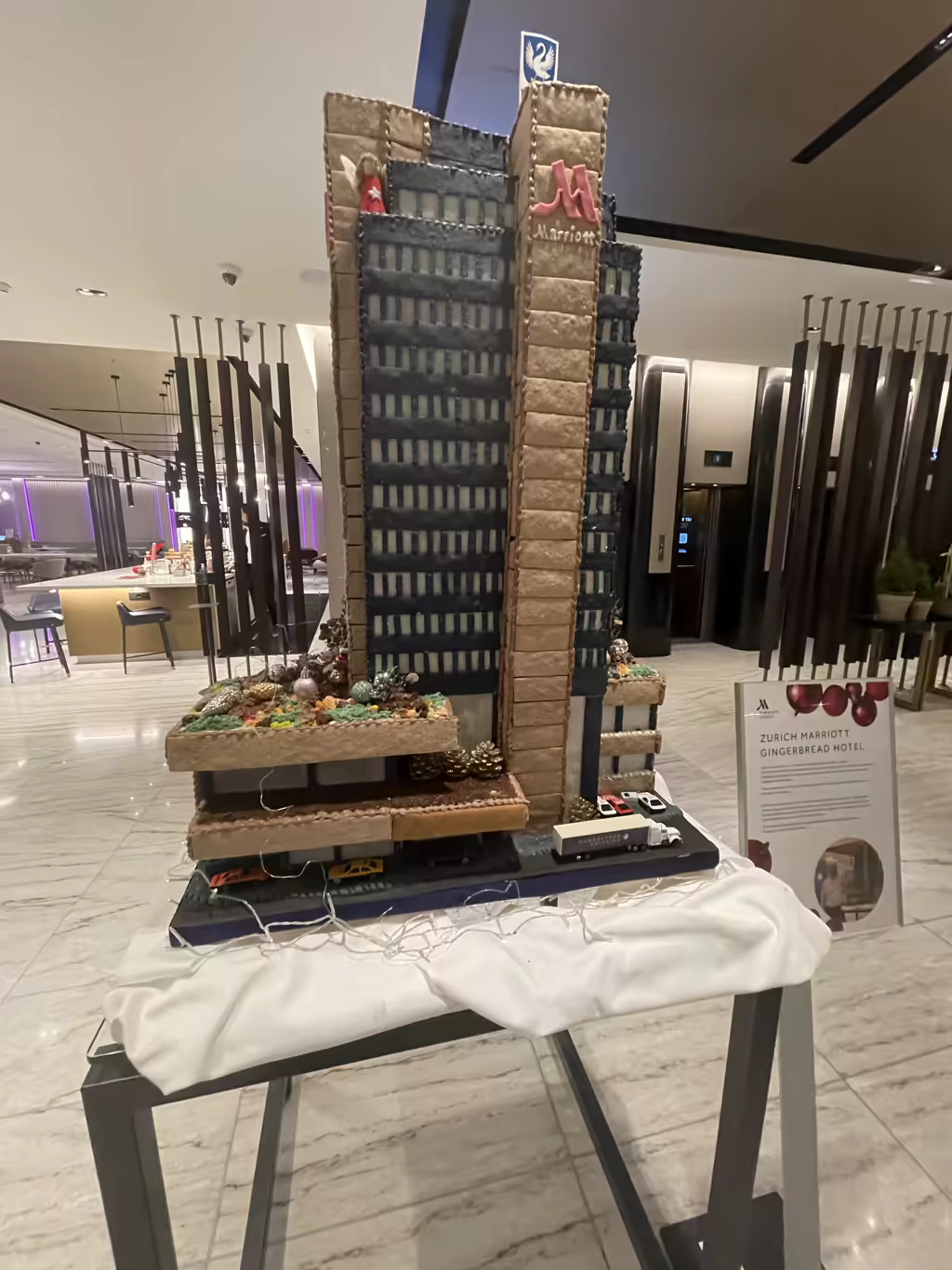 A detailed gingerbread model of the Zurich Marriott hotel on display in the hotel lobby.