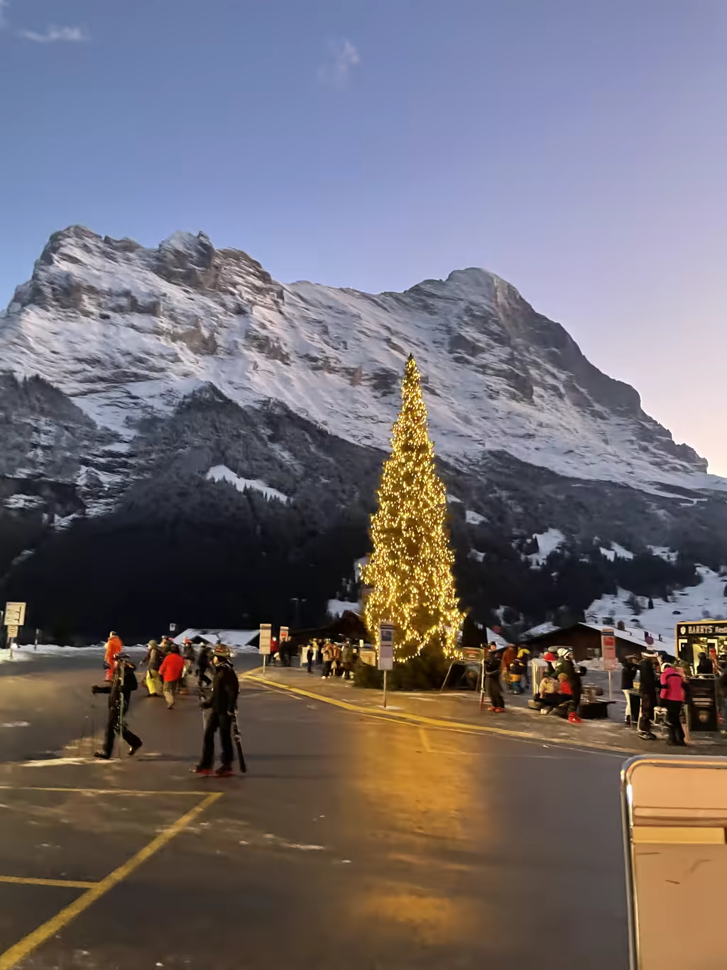 Lit up for the holidays, a towering Christmas tree greets families at the base of the Eiger.
