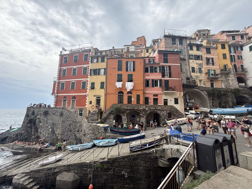 Colorful buildings and fishing boats at the waterfront in Riomaggiore, Cinque Terre, Italy.