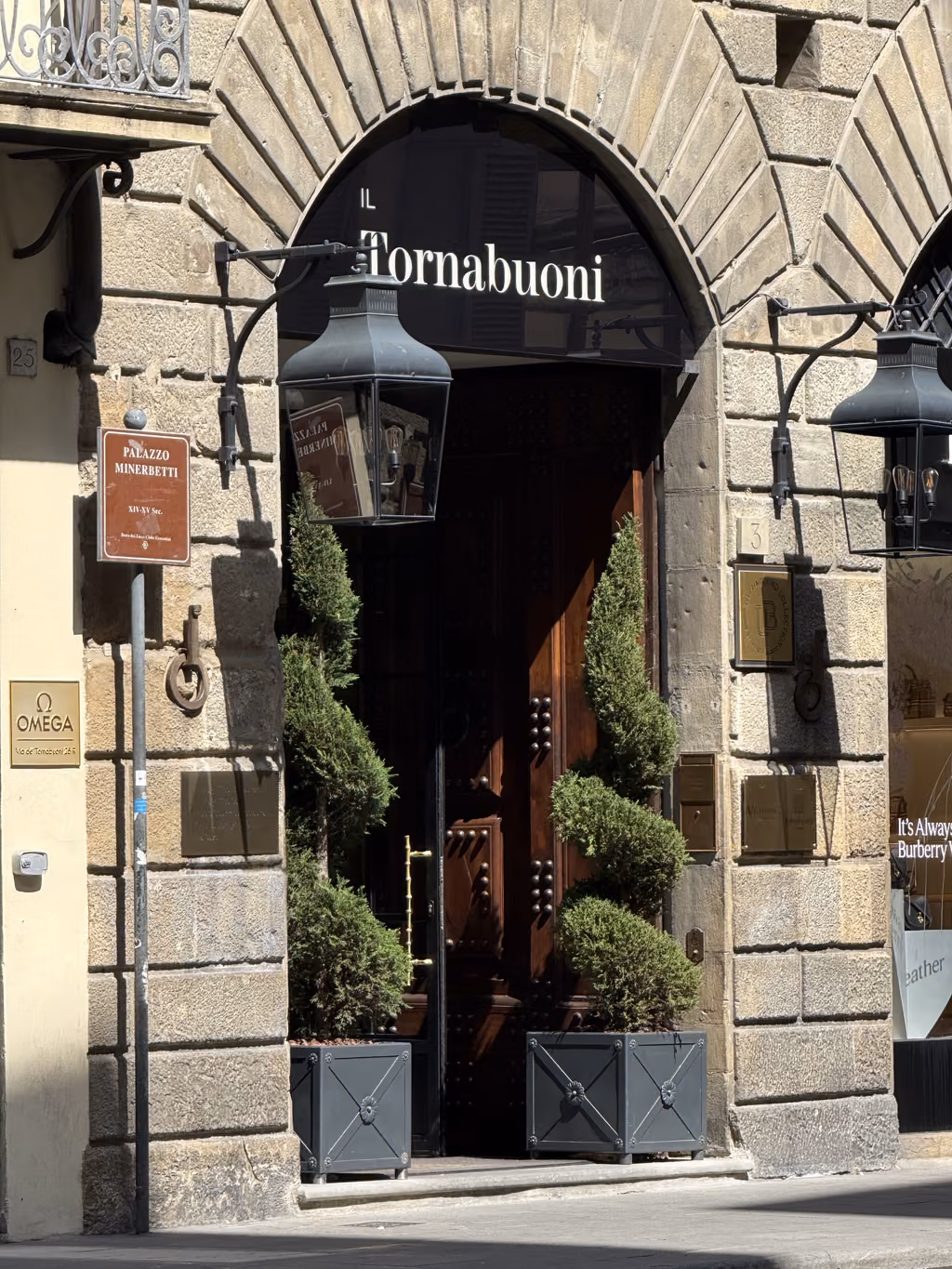 Ornate wooden entrance to Il Tornabuoni hotel at Palazzo Minerbetti in Florence, Italy.