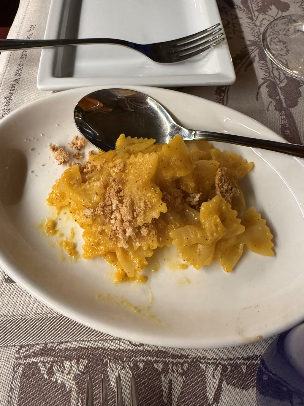 Bowl of farfalle pasta topped with breadcrumbs at Acqua al 2 restaurant in Florence, Italy.