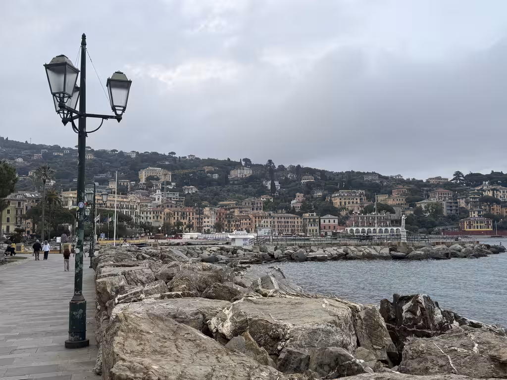 Promenade with a lamp post overlooking the seaside buildings of Santa Margherita Ligure, Italy.