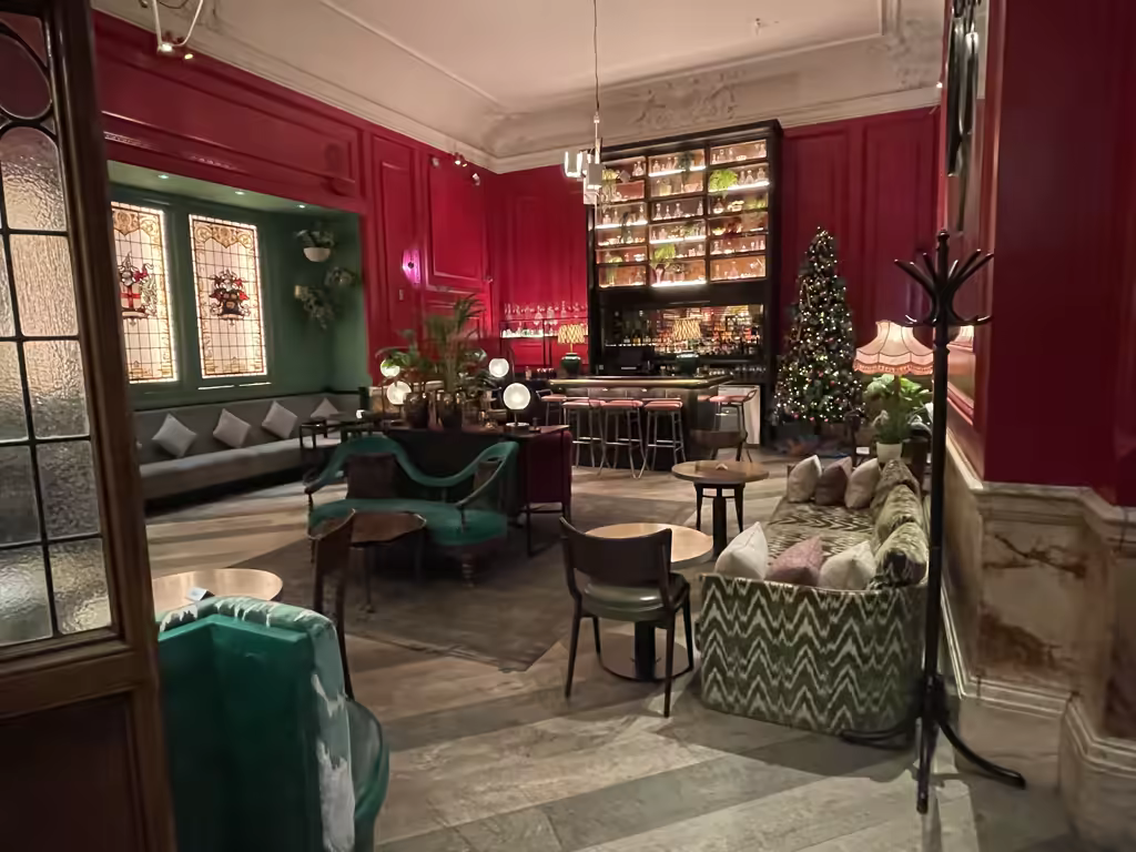 Enjoy a festive afternoon tea surrounded by the elegant, holiday-adorned interiors of a classic London hotel.