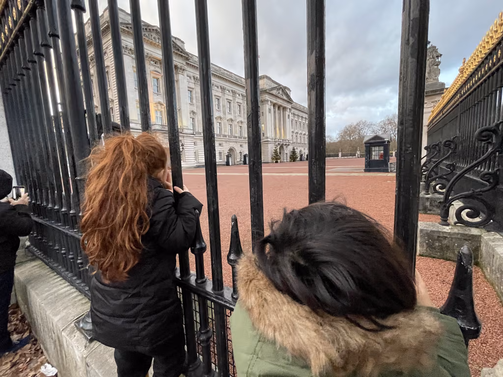 Peeking through the iconic iron gates at Buckingham Palace is a must for your London itinerary.