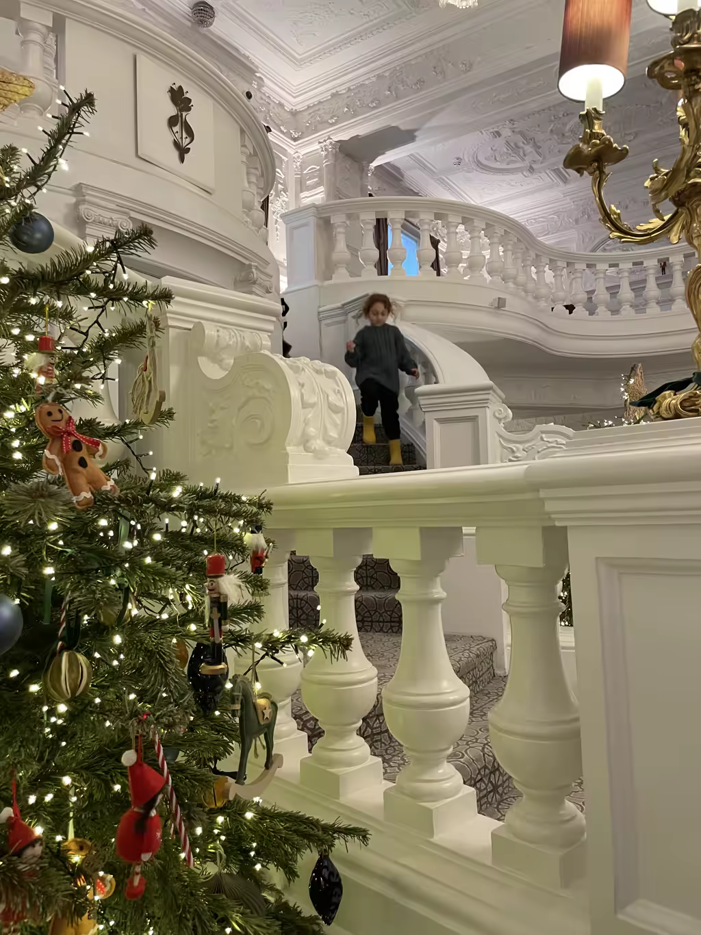 Nothing captures the festive magic of a London stay quite like descending a grand, decorated staircase.