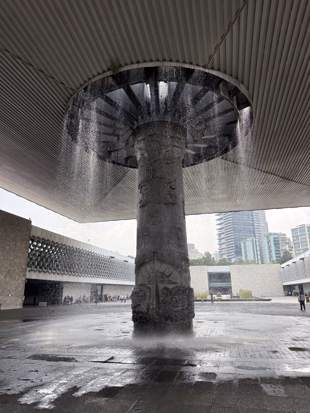 Water cascades from the large, carved umbrella fountain at the National Anthropology Museum.