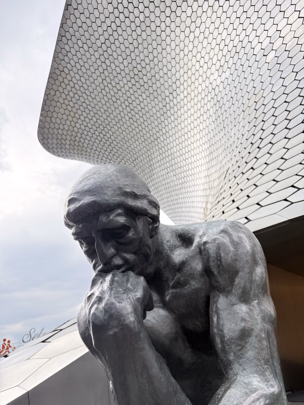 The iconic Thinker sculpture stands in front of the striking architecture at Museo Soumaya in Polanco.