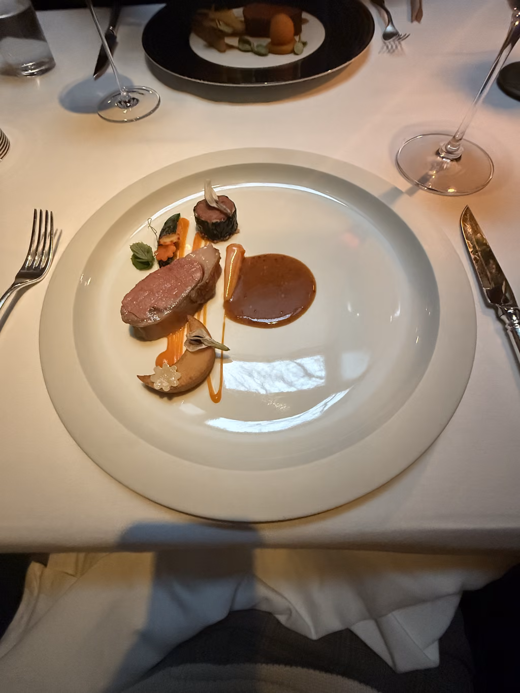 Savoring a perfectly cooked, artfully presented dish during our exquisite birthday dinner at The French Laundry.