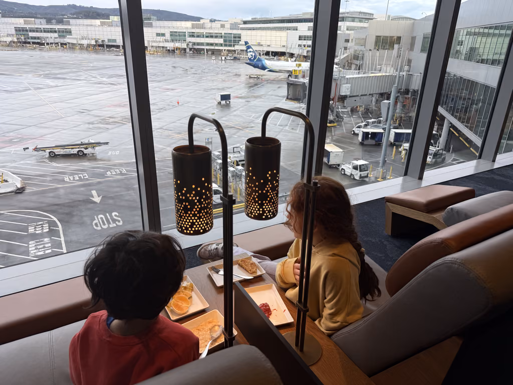 Children eating breakfast by the window at San Francisco International Airport overlooking the tarmac