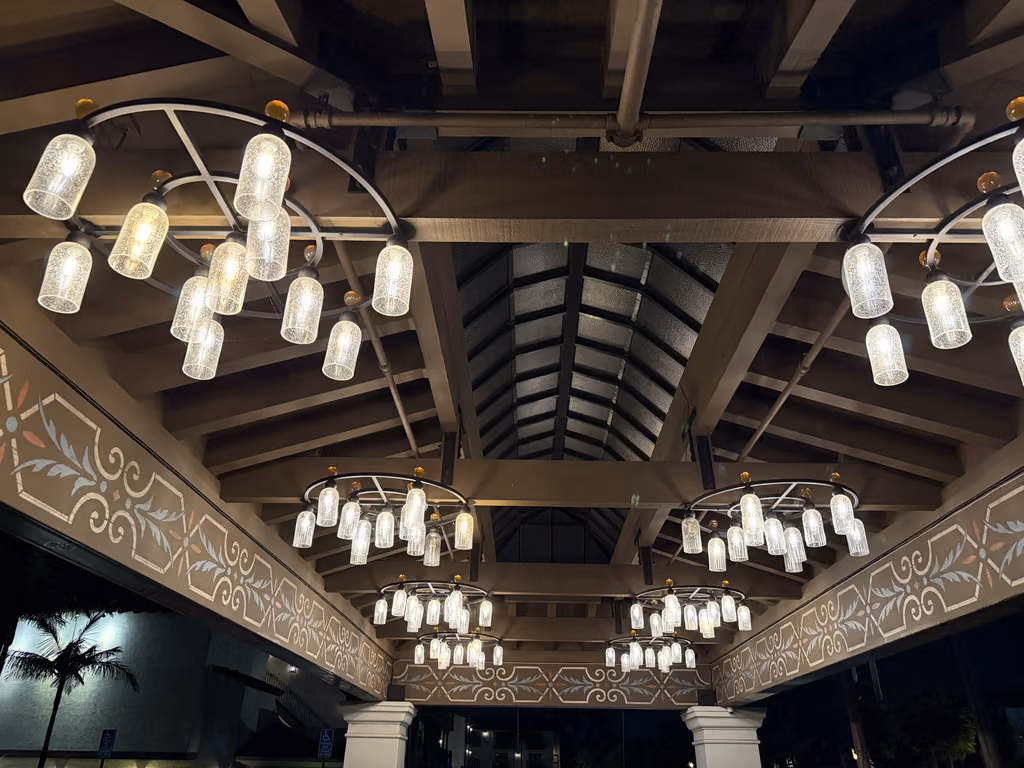 The grand entryway of this Santa Barbara resort features elegant, glowing chandeliers and intricate detailing.