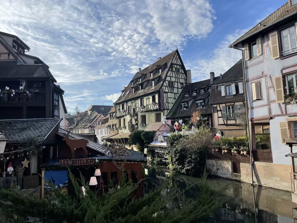 The charming canals of Little Venice in Colmar sparkle with festive decorations during the holiday season.