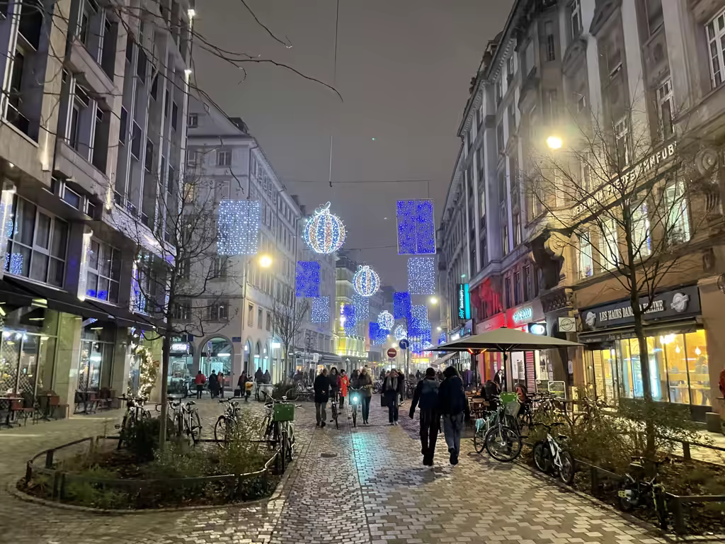 Cobblestone streets of Strasbourg glow with enchanting holiday lights, creating an inviting atmosphere for evening strolls.