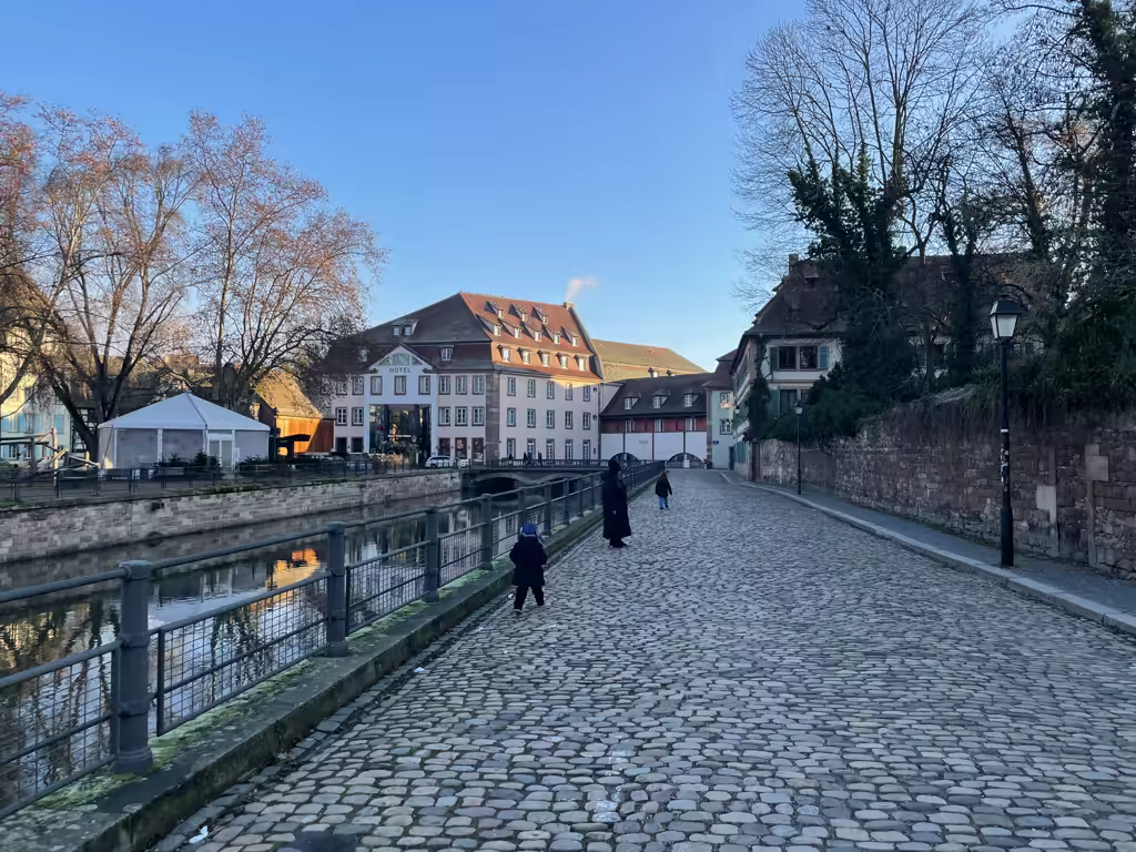 Stroll the serene, cobblestone paths along the canal in Strasbourg, far from the busy market crowds.