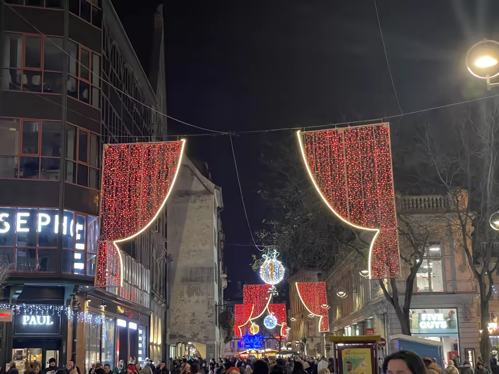 Strasbourg shines at night with stunning light installations draped above the bustling pedestrian shopping streets.