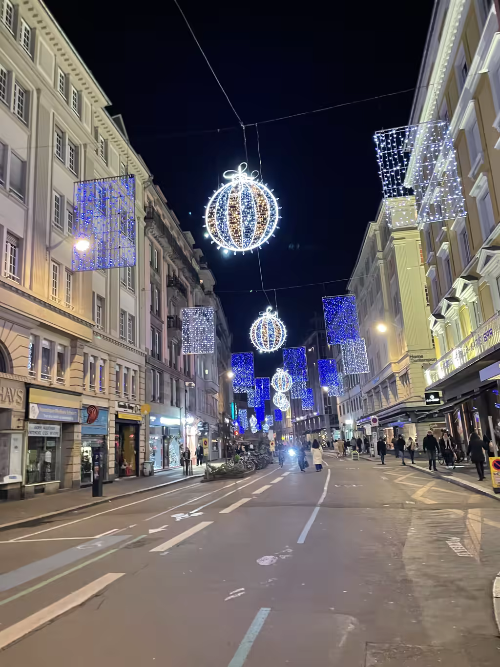 Strasbourg transforms into a sparkling wonderland with festive street lights illuminating its historic city center paths.