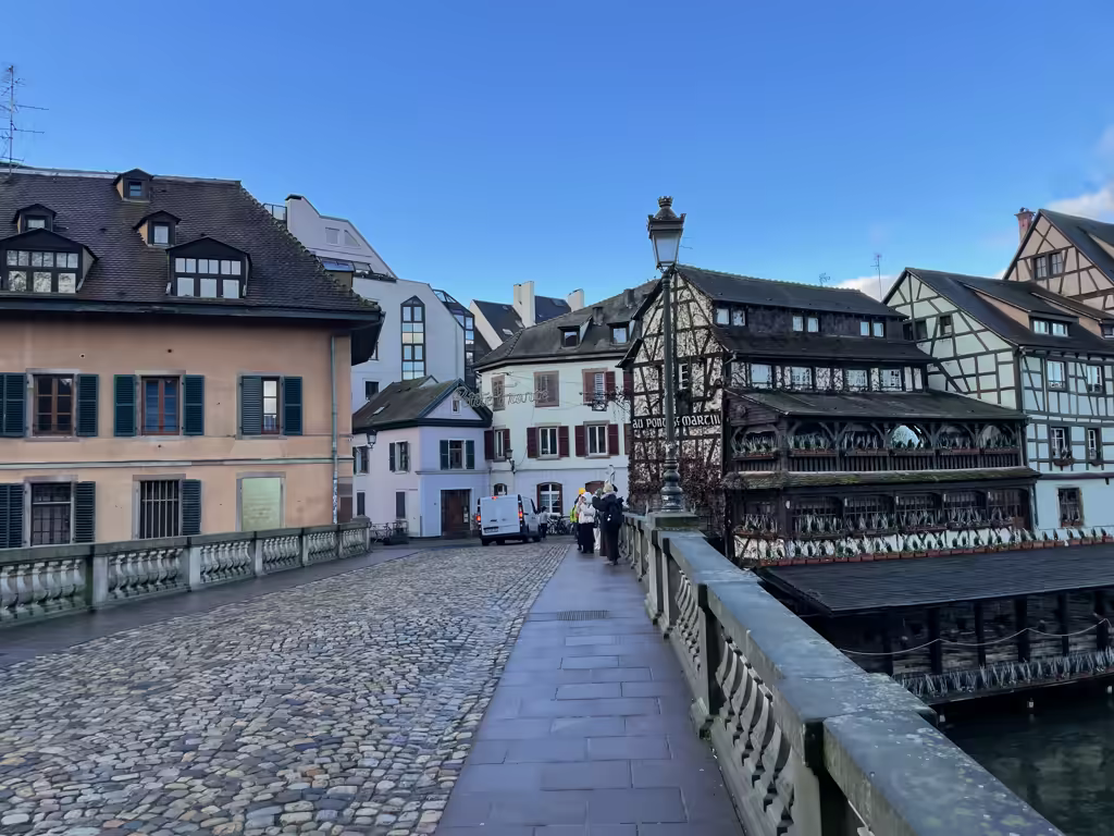 Cobblestone streets and timbered buildings frame the scenic charm of Strasbourg’s historic Pont Saint-Martin bridge.