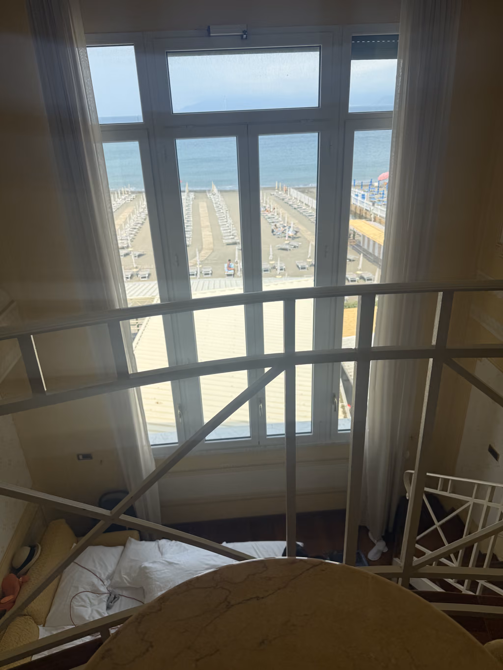 Loft bedroom view looking out over the beach in Sestri Levante at Albergo Suite Hotel.